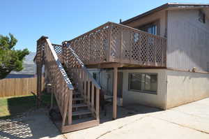 Back of property with a patio area and a wooden deck