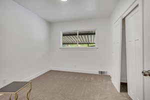 Unfurnished bedroom with carpet and baseboards