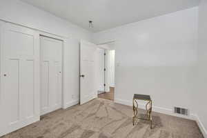Unfurnished bedroom featuring carpet floors and baseboards