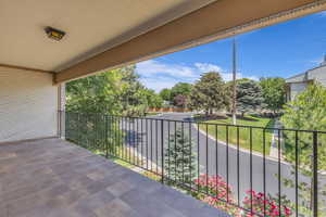 View of patio featuring a balcony