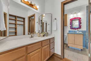 Bathroom featuring ornamental molding, vanity, toilet, tile patterned flooring, and baseboards