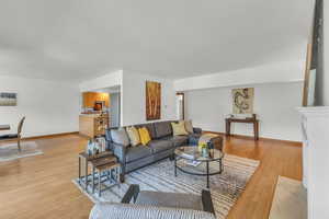 Living area featuring light wood finished floors and baseboards