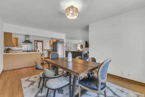 Dining space with light wood-style floors and baseboards