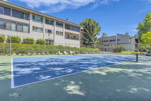 View of tennis court with community basketball court
