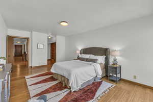 Bedroom featuring light wood-type flooring and baseboards