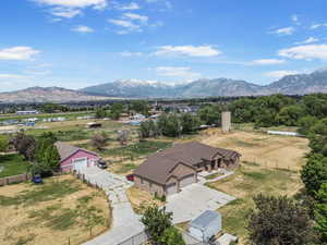 Aerial view of property with acreage and silo with a mountainous background