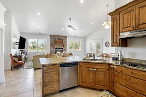 Kitchen featuring stainless steel dishwasher, under cabinet range hood.