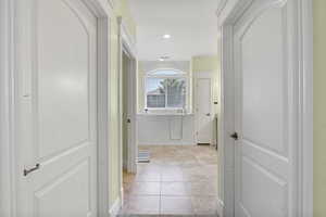 Walkway from master bedroom into master bathroom with double closets.