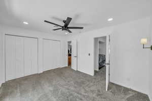 Unfurnished bedroom featuring washer and dryer, carpet floors, recessed lighting, two closets, and baseboards
