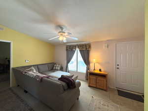 Living room featuring a ceiling fan