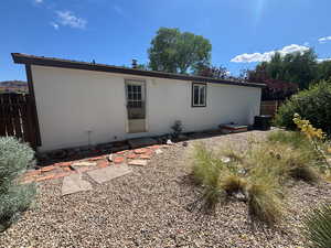 Back of house with central AC unit
