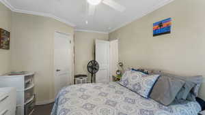 Bedroom 1 with crown molding and a ceiling fan