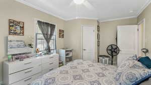 Bedroom 1 featuring crown molding and ceiling fan