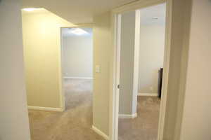 Hall with carpet and baseboards