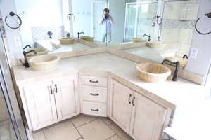 Full bathroom with a tub to relax in, double vanity, and a shower stall
