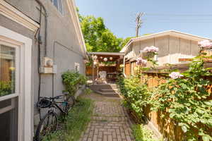 View of property exterior featuring a fenced backyard, a wooden deck, and stucco siding