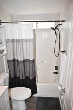 Full bath featuring toilet, vanity, shower / bath combo, and wood finished floors