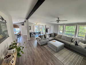 Living area with a ceiling fan, healthy amount of natural light, and wood finished floors