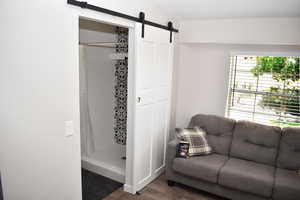 Interior space with a barn door and wood finished floors