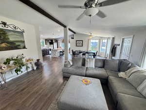 Living area with a ceiling fan, dark wood-type flooring, and recessed lighting