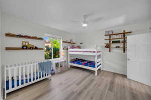 Bedroom featuring wood finished floors, ceiling fan, and baseboards
