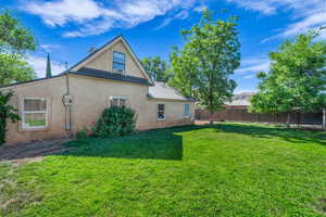 Back of property featuring stucco siding, metal roof, and a standing seam roof