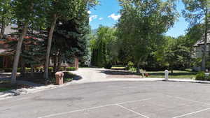 View of asphalt road featuring sidewalks and curbs