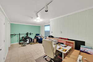 Office featuring a textured ceiling, light tile patterned flooring, crown molding, baseboards, and track lighting