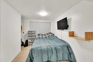 Bedroom featuring tile patterned floors and baseboards
