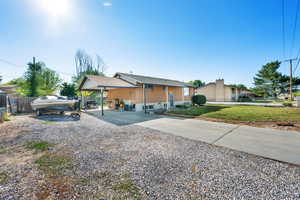 View of front of home with gravel driveway