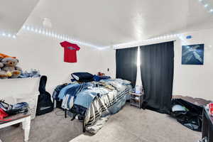 Carpeted bedroom with a textured ceiling