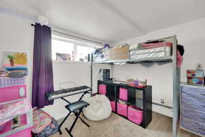 Bedroom featuring carpet, baseboards, and a textured ceiling