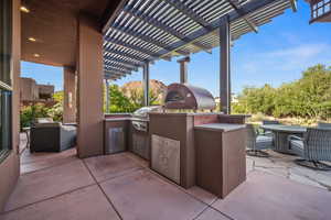 View of patio featuring a pergola and outdoor dining area