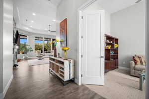 Corridor featuring baseboards, wood finished floors, and recessed lighting