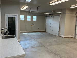 Garage with a sink and baseboards