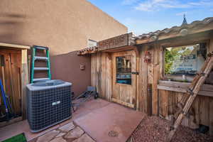 Exterior view of cooling unit and stucco siding