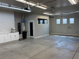 Garage with water heater and a garage door opener
