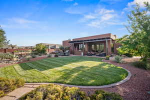 View of green lawn featuring outdoor lounge area and a patio area
