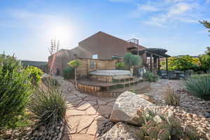 View of patio / terrace with a covered hot tub and a balcony