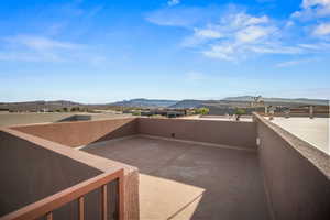 View of patio featuring a mountain view and a balcony