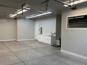 Garage with electric panel and a garage door opener