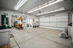 Garage featuring a garage door opener and an AC wall unit
