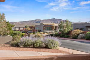 Pueblo-style house with a mountain view and stucco siding