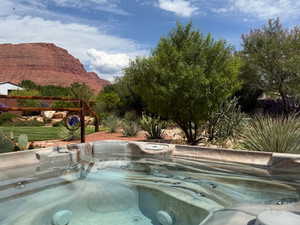 View of property's community with a jacuzzi and a mountain view