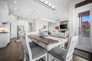 Dining room with dark wood-style flooring, recessed lighting, and ceiling fan