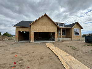 Property in mid-construction with a garage and driveway