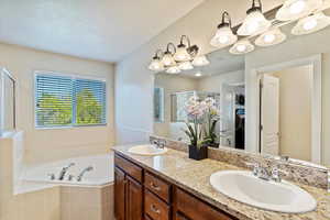 The Primary bath's double vanity with granite counters and ample lighting.
