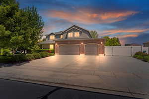 View of front of house featuring RV parking and backyard storage and access  gate, brick siding, concrete driveway, and an attached garage