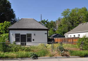 Rear view of property featuring a shingled roof