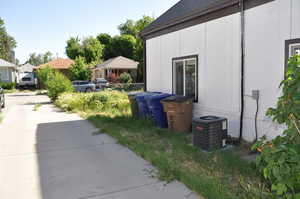 View of side of home with central AC unit